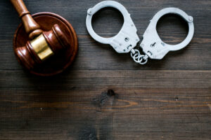 handcuffs and gavel on table