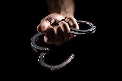 open handcuffs in hand